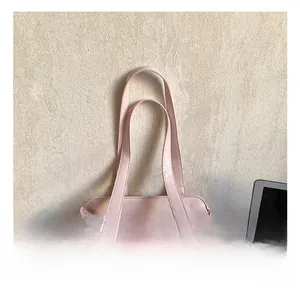 Detail showing pink pleated Boston bag with silver metal rings and smooth handles