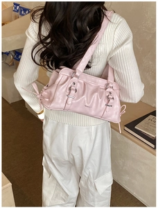 Detail of light pink pleated Boston bag with silver buckle and elegant RU texture
