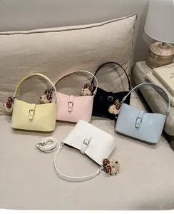 Detailed view of luxury leather underarm bags in five colors with cute bear charms