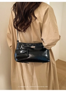 Detailansicht der schwarzen Vintage Eimertasche mit Drehverschluss und Mini-Tasche am Mantel