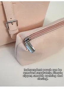 Detail view of pink leather hobo bag with removable inner pouch and silver hardware