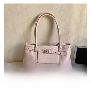 Detail showing pink leather tote bag with silver studs and decorative buckle strap detail