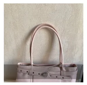 Detailed macro view of the comfortable soft handles and smooth stitching on this pink tote bag