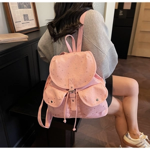 Pink star-patterned backpack featuring dual front pockets and drawstring flap closure