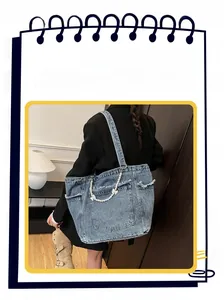 Detail of washed denim tote bag featuring pearl chain strap and sweet ribbon bow accent