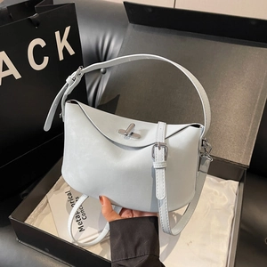 Minimalist light blue leather bucket bag with silver turn-lock and adjustable strap