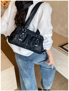 Detail of black pleated shoulder bag with silver hardware and Wishera brand logo