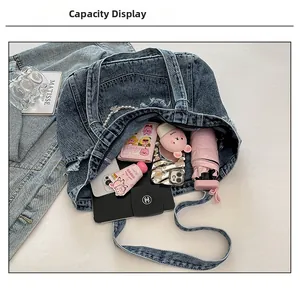 Top view of large washed denim tote bag showing interior space and various accessories