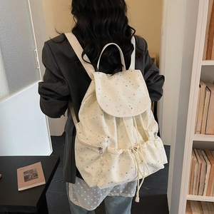 Detail of Korean style drawstring backpack with silver star print and metal zipper pockets