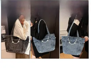 Detail view of large denim tote bags in grey, classic blue and light blue washes