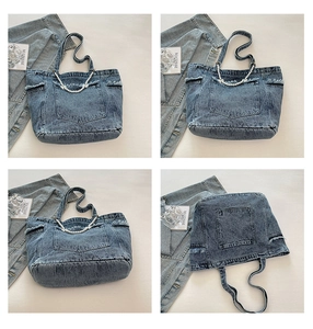 Detail of blue washed denim tote bag with raw edges and removable pearl chain accessory