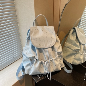 Light blue drawstring backpack with silver star pattern in a stylish preppy aesthetic