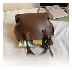 Detail view of large capacity dark brown leather tote bag showing internal storage space