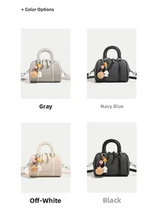 Detail view of lychee leather Boston bags in gray, navy, white and black with cute charms