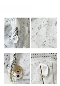 Detail view of large capacity backpack with lightning marble pattern and teddy bear charm