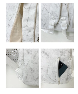 Detail of marble pattern backpack featuring breathable mesh straps and side zipper pocket