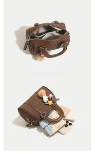 Internal view of the brown Boston bag showing large capacity and organized compartments