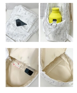 Detail view of large capacity marble pattern backpack with side pockets and inner slots