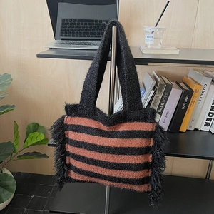 Striped knit tote bag with fringe details and mohair texture for autumn winter fashion