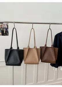 Detailed display of vintage tote bags in black, beige, and brown with pebble leather texture