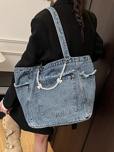 Large washed denim tote bag with pearl bow chain and front pocket for women