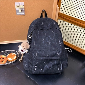 Black casual backpack with white lightning pattern and plush bear charm for students