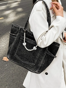 Large washed denim tote bag in black with pearl bow chain and fringe edge details