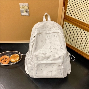 Detail view of large capacity white marble pattern backpack with side drawstring pocket