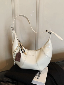 Fashionable cream hobo underarm bag with unique patchwork and decorative chain strap