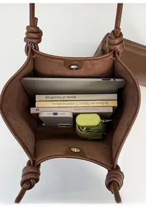 Vertical view of the large capacity tote bag interior with storage sub-bag and brown leather