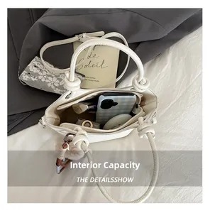 Top view of white bucket bag showing internal capacity with phone and cosmetics