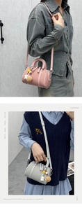 Detail of pink and grey mini Boston bags with plush star charms and adjustable straps