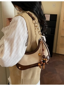 Sac croissant chic beige et marron avec chaîne en métal et pompon en perles de bois