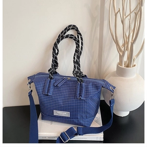 Detailed macro view of the blue checkered canvas bag with thick woven rope handles