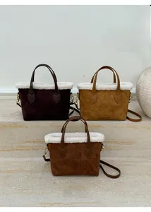 Three plush bucket bags in brown and monogram patterns on marble display steps