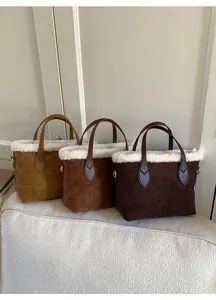 Detailed view of plush trim tote bags with vintage embossed suede texture and leather handles