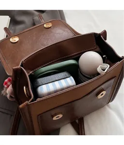 Detail view of the spacious interior of a brown vintage leather backpack with magnetic closure