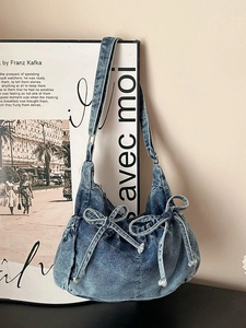 Blue denim shoulder bag with bow knot and pleated drawstring design in casual style