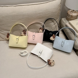 Detailed view of minimalist crossbody bags in five colors with cute teddy bear charms