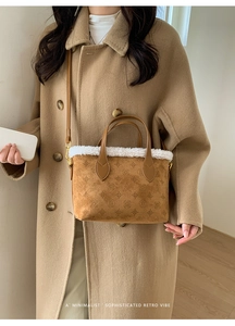 Detail of plush brown suede bucket bag with white faux fur trim and embossed pattern