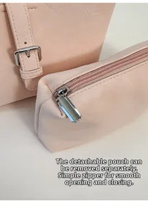 Detail view of pink leather bag set featuring a removable inner pouch with smooth zipper