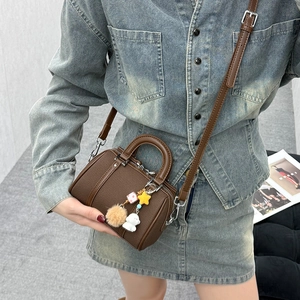 Dark brown pebble leather Boston bag with cute bear charm and detachable strap for women