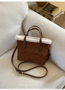 Close-up of brown suede bucket bag with white faux fur trim and vintage embossed patterns