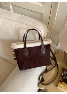 Detail of plush tote bag with vintage embossed texture and faux fur trim on sofa