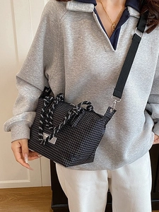 Chic black and white checkered crossbody bag with rope handle and nylon shoulder strap