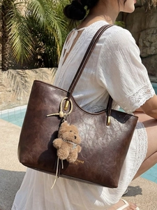 Classic dark brown tote bag with vintage lychee texture and cute bear pendant charm