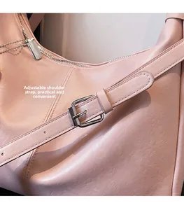 Detail view of pink tote bag with adjustable silver buckle strap and smooth PU texture