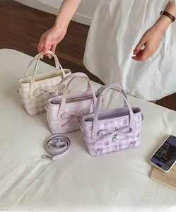 Detailed view of mini tote bags featuring cute bear patterns and 3D bows with heart charms