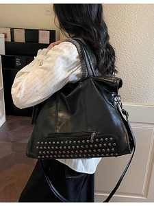 Vintage black faux leather tote bag with silver rivets and adjustable shoulder strap