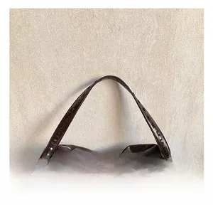 Detail view of the dark brown leather tote showing wide comfortable handle and woven edges